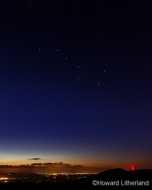 Clwydian range hills at night with stars and Moel-y-Parc transmitter mast