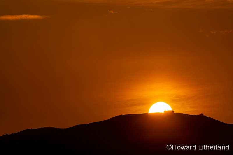 Sunset over the Jubilee Tower on the summit of Moel Famau, North Wales
