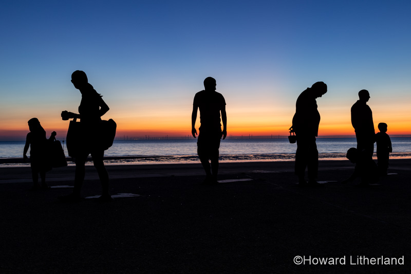 Sculptures of families on the seafront at Colwyn Bay at dawn, North Wales