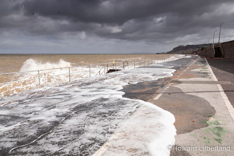 Waves crashing on Colwyn Bay seawall in a storm at high tide on the North Wales coast