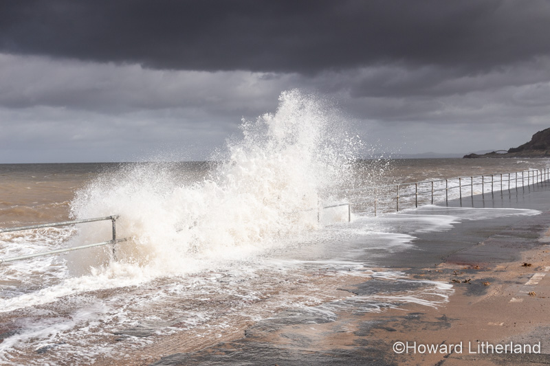 Waves crashing on Colwyn Bay seawall in a storm at high tide on the North Wales coast