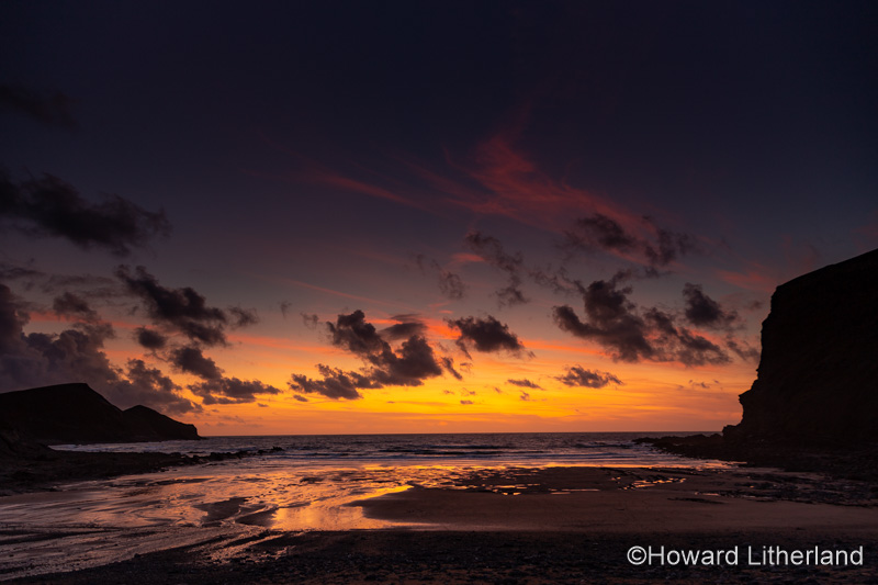 Sunset over the Atlantic ocean from Crackington Haven on the north Cornwall coast