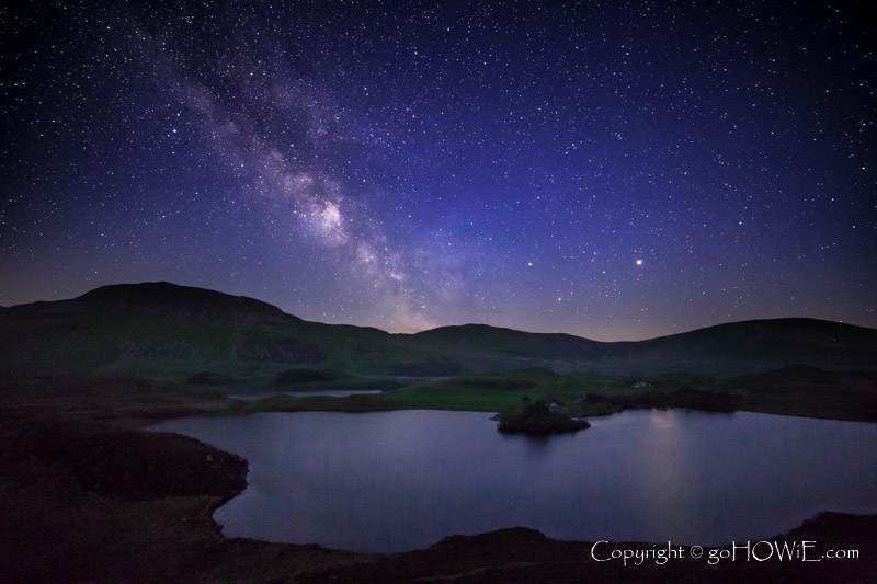 The milky way over Cregennan Lakes, with Cader Idris in the background, Snowdonia National Park, Wales