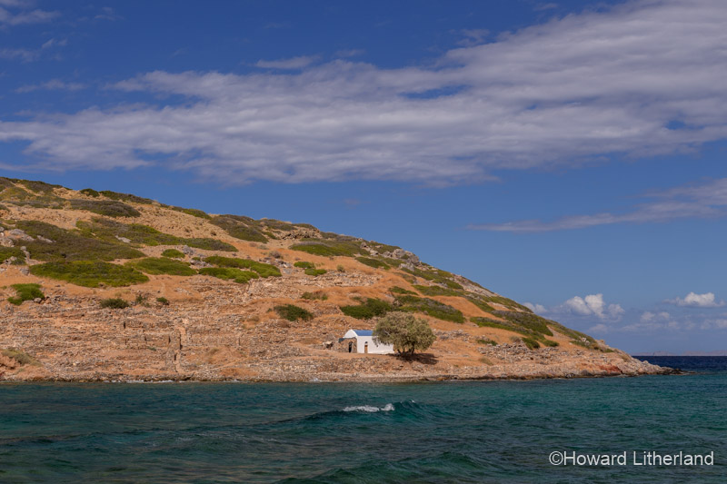 Offshore island with small greek orthodox church at Mochlos on the Mediterranean island of Crete