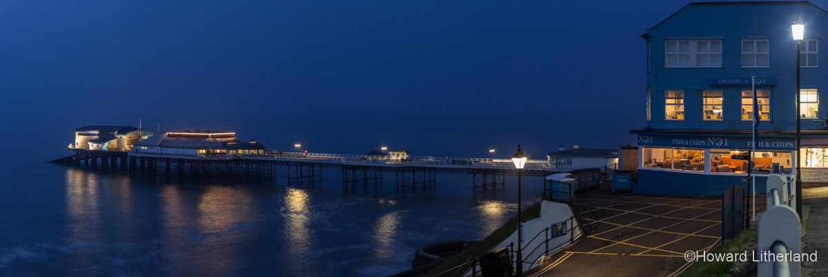 Panoramic image of the pier at Cromer on the Norfolk coast as seen from the esplanade at twilight