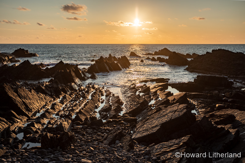 Sunset over the Atlantic ocean at Hartland Quay, Devon, England