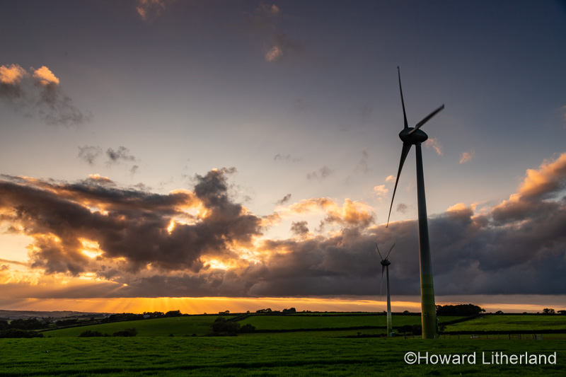 Wind turbines in a field at sunset, Devon, England