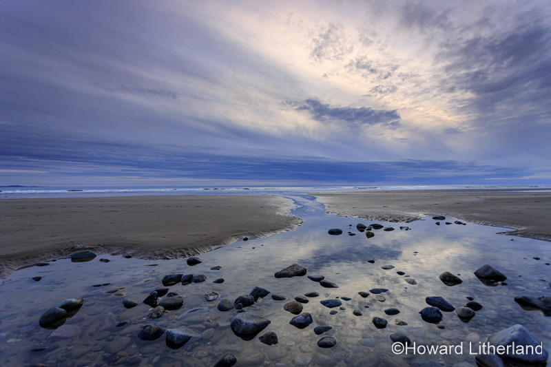 Clouds at sunset over Dinas Dinlle beach, North Wales