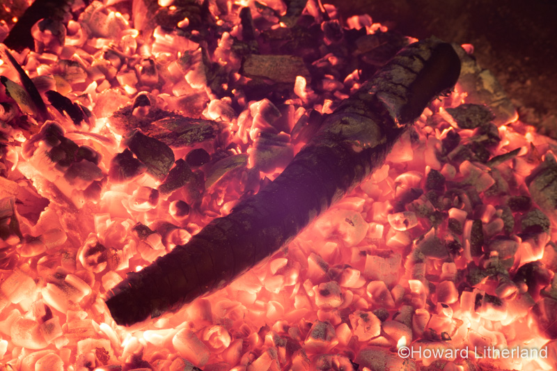 Glowing hot bonfire wood embers