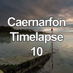 Time lapse video sunset and dusk on a cloudy evening over the Menai Straits from the seawall at Caernarfon on the North Wales coast