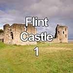 This video shows the ruins of Flint castle on the North Wales coast at high tide with a flock of starlings flying overhead