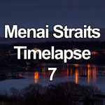 Time lapse video showing storm clouds passing over Thomas Telford's suspension bridge spanning the Menai Straits, Anglesey, North Wales, followed by the bridge lights coming on at dusk and reflecting in the water