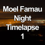 Time lapse video showing mist and clouds swirling over the lights of towns and cities at night as seen from the summit of Moel Famau