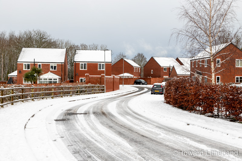 Houses and road covered in snow in winter, North Wales