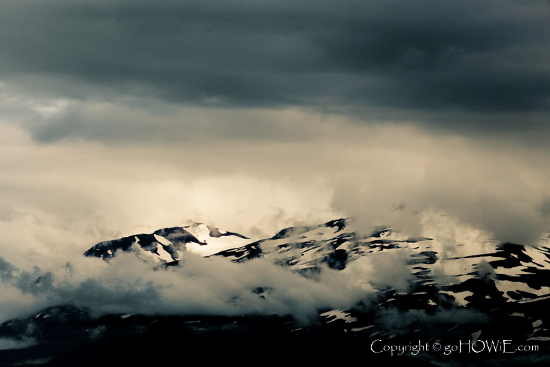 Snow and cloud capped mountains along the Eyjafjordur fjord at Akureyri, Iceland
