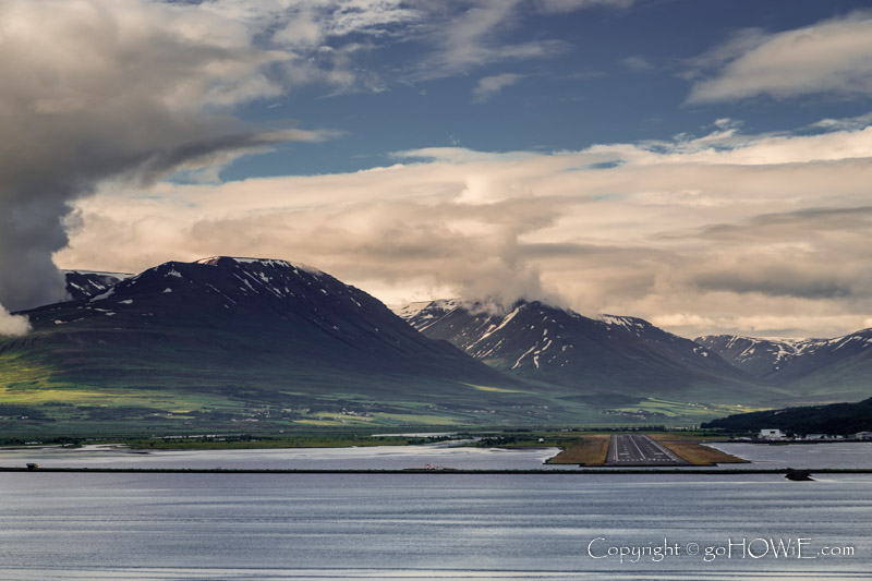 The airport at Akureyri, Iceland, built out into the end of the Eyjafjordur fjord with mountains behind