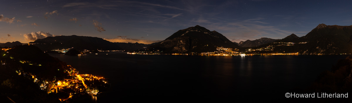 Panoramic image overlooking the centre of Lake Como, Varenna and mountains in northern Italy at night