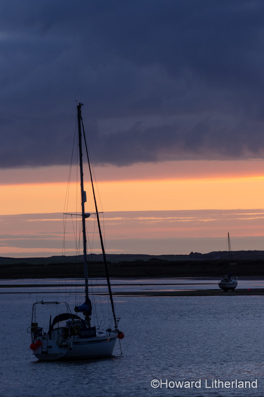 Yacht in silhouette at Ravenglass, Lake District, England
