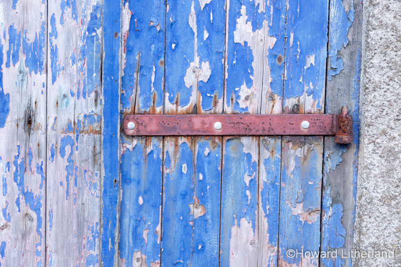 Old blue wooden door at Ravenglass, Lake District, England