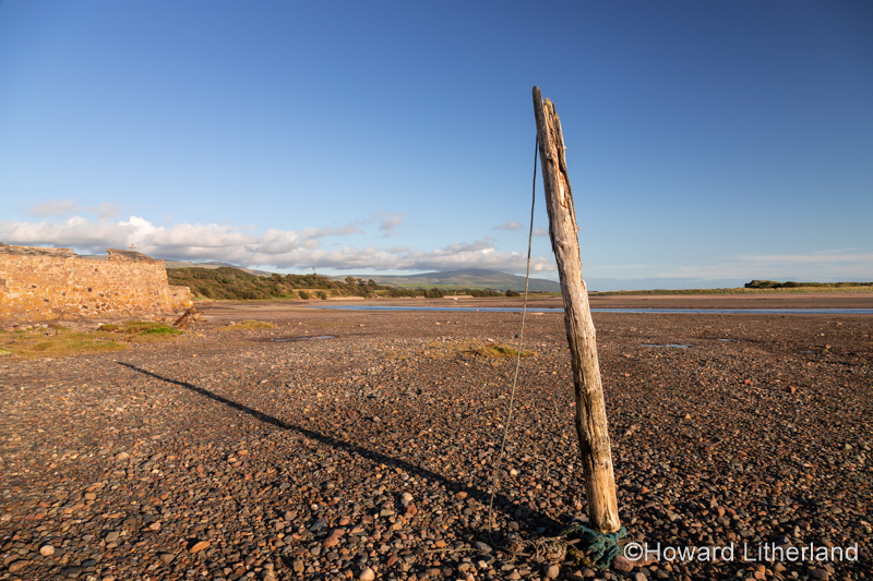 Old mooring post on the beach at Ravenglass, Lake District, England