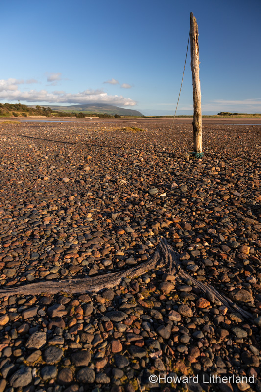 Old mooring post on the beach at Ravenglass, Lake District, England