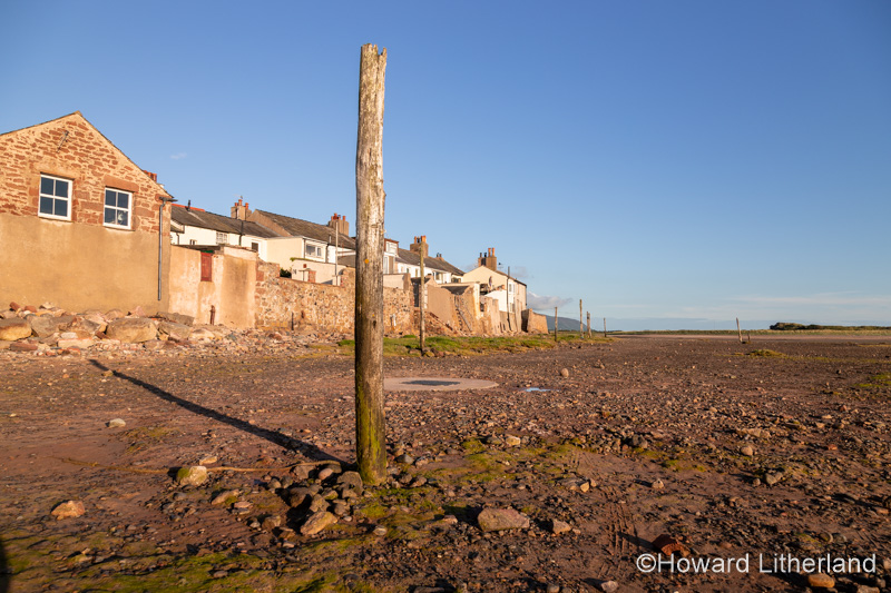 Old mooring post and houses at Ravenglass, Lake District, England