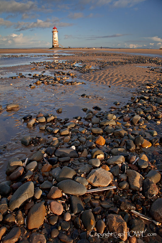 Lighthouse and stones on the beach at Talacre, North Wales