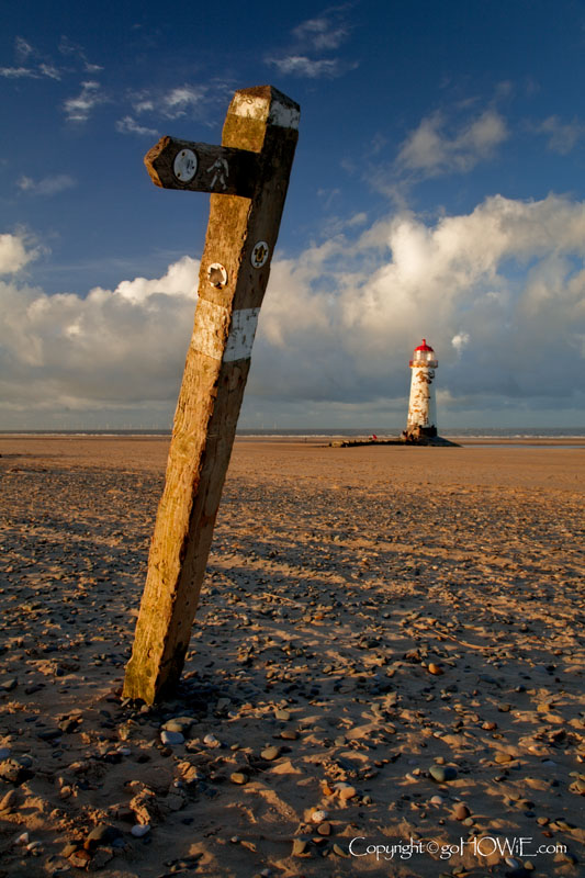 Point of Ayr lighthouse and old wooden sign, Talacre, North Wales