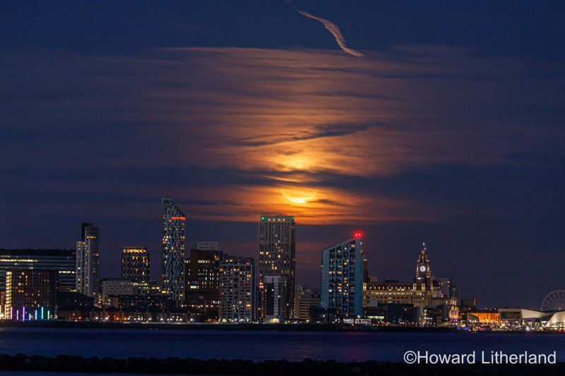 Supermoon rising over the Liverpool waterfront skyline, Merseyside, England