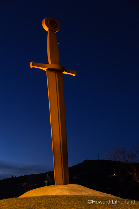 King Arthur lengend sword in the stone Excalibur sculpture at night at Llanberis in Snowdonia, North Wales