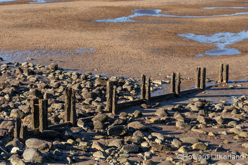 Groynes at Llanfairfechan beach on the North Wales coast