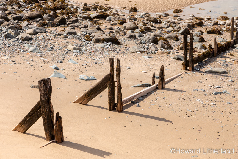 Decaying groynes on the beach at Llanfairfechan, North Wales