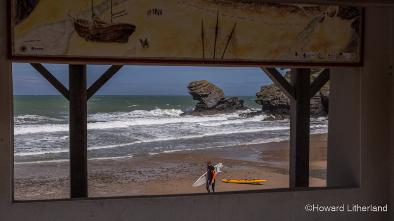 Surfer on the beach at Llangrannog on the Ceredigion coast, Mid Wales