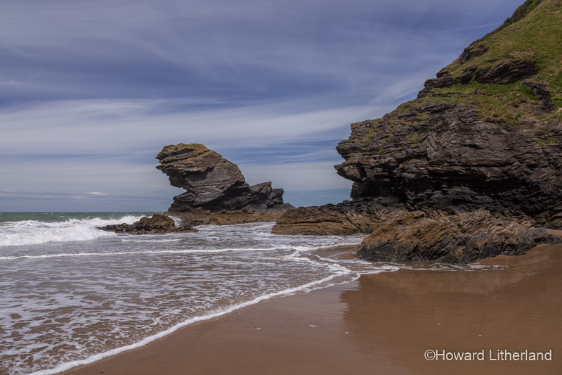 Rocks, sand and waves at the beach at Llangrannog on the Ceredigion coast, Mid Wales