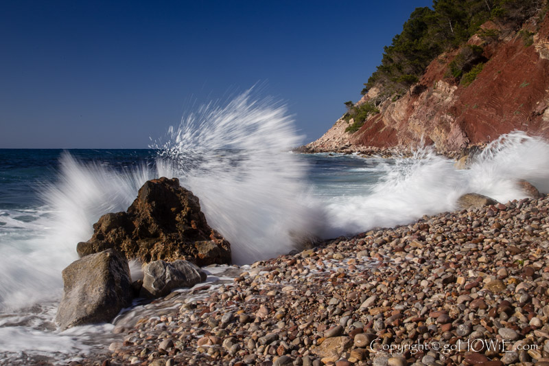 Wave breaking on the stony beach at Port de Valldemossa on the west coast of Mallorca