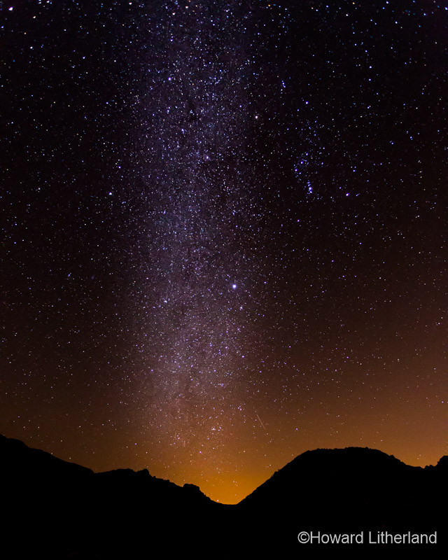 Milky way rising up vertically over the volcanic hills of the Teide National Park on Tenerife in the Canary Islands