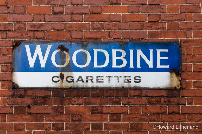 Old sign advertising Woodbine cigarettes at Waybourne station, Norfolk, England