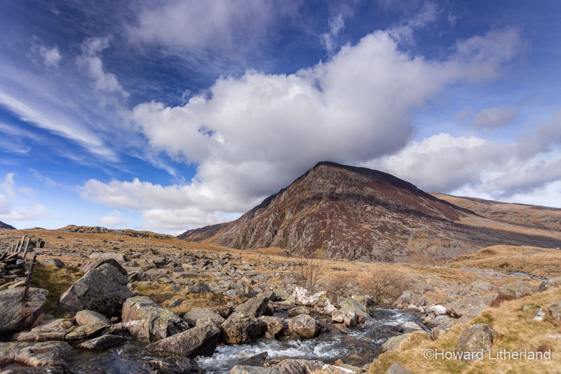 Frozen shoreline of Llyn Ogwen in Snowdonia, North Wales, with Pen yr Ole Wen mountain in the background