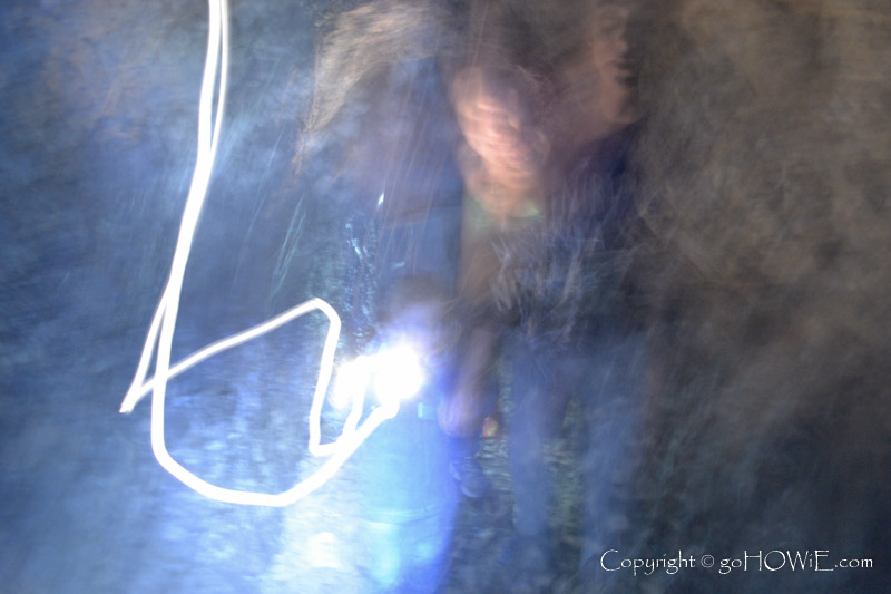 Abstract image of blurred people in a cave with a torch