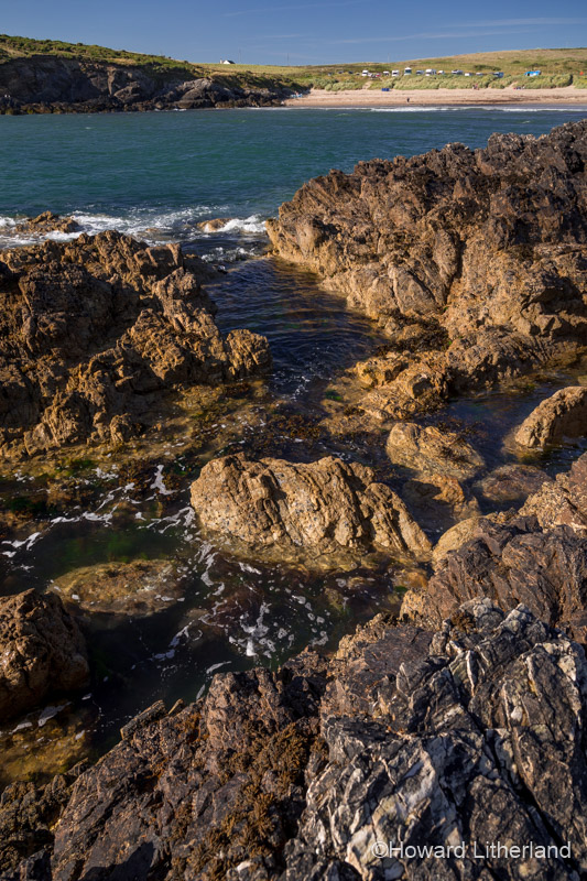 The beach and rocks at Porth Trecastell on Anglesey on the North Wales coast