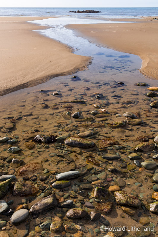 Runoff stream on the beach at Porth Trwyn, Anglesey, North Wales