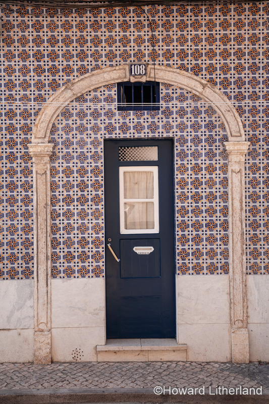 Door set in a blue tiled wall, Lisbon, Portugal