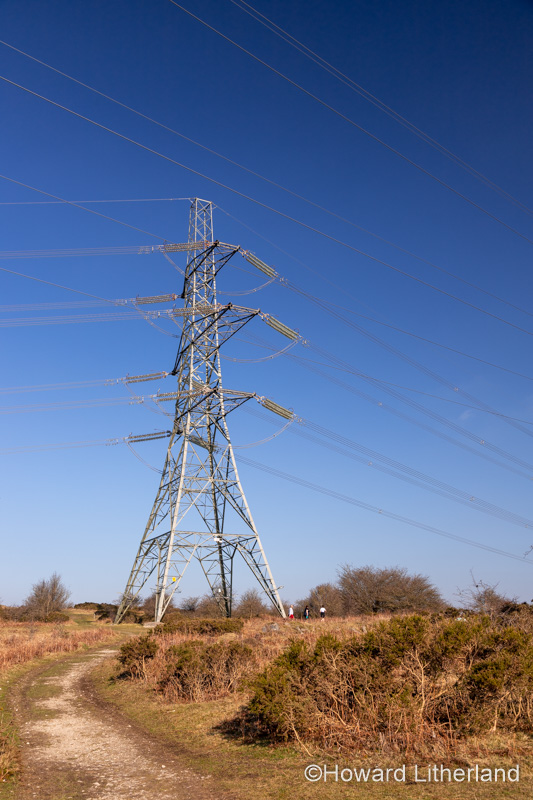 Electricity pylon and cables against a blue sky