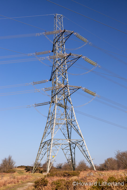Electricity pylon and cables against a blue sky