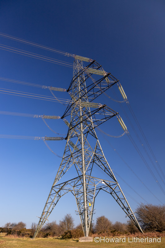 Electricity pylon and cables against a blue sky