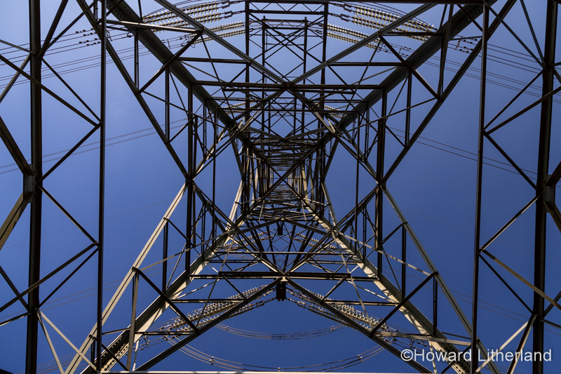 Electricity pylon and cables against a blue sky