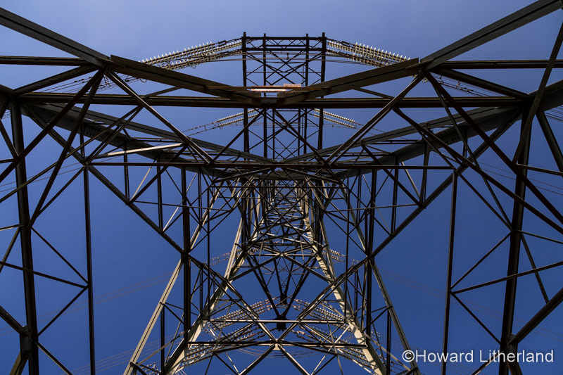 Electricity pylon and cables against a blue sky