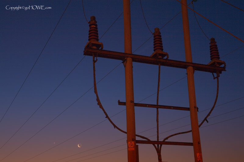 Photo of pylon and moon by the river Dee just before sunrise at Queensferry, North Wales