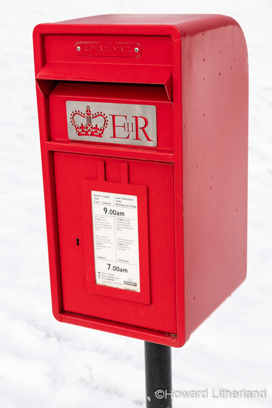 Red Royal Mail postbox in the snow
