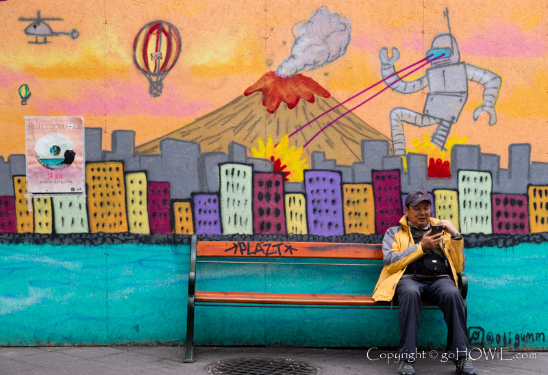 Graffiti street art and sitting man, Reykjavik, Iceland